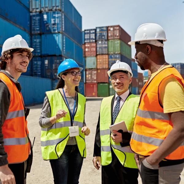 container dock four people talking
